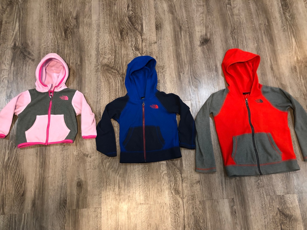 Three North Face Glacier Full-Zip Fleece Hoodies in infant, toddler, and youth sizes, colors pink, blue, and reg