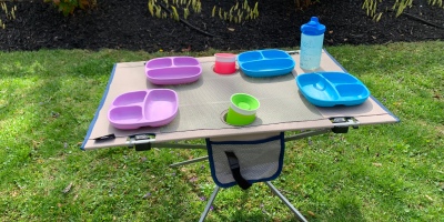 Ozark Trail Folding Table set up with kids plates and cups showing how you can easily fit at least 4 kids at the table.