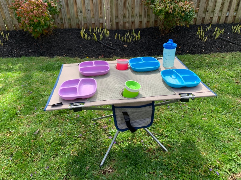 Ozark Trail Folding Table set up with kids plates and cups showing how you can easily fit at least 4 kids at the table.