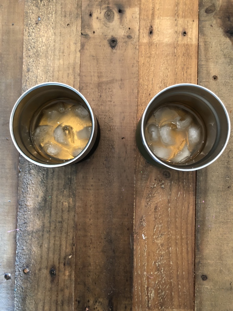 Whiskey and slightly melted ice in Coleman and Yeti tumblers