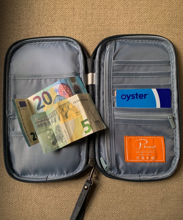 Inside view of the zippered passport wallet containing cash and travel cards