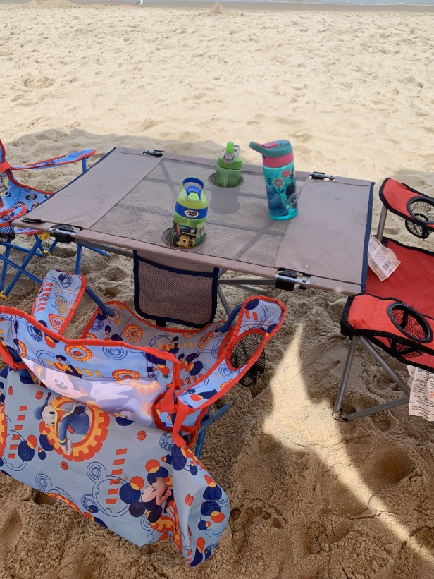 Ozark Trail folding camping table ready for a meal on the beach