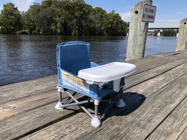 Summer Infant Pop 'N Sit Booster Chair on a dock near a river