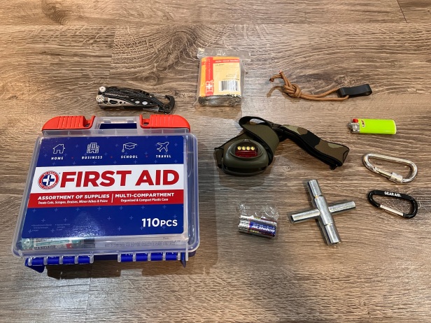 Survival gear for get home bag including first aid kit and headlamp